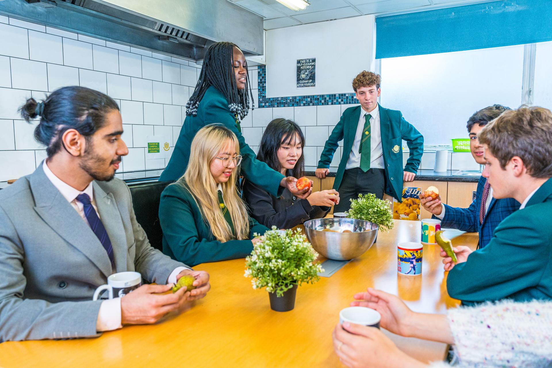 St James pupils gathered around a table with a member of staff