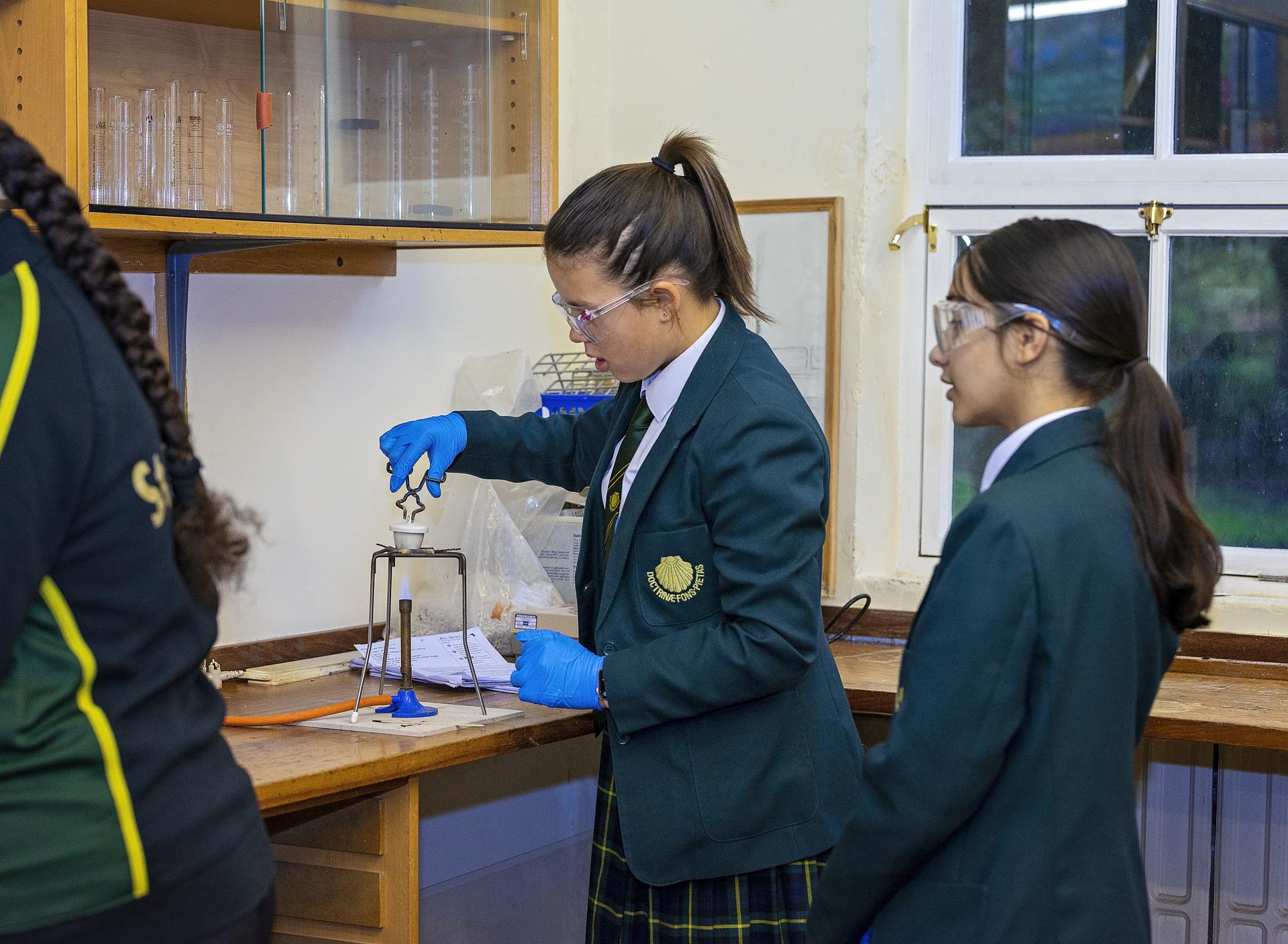 Pupils working with a teacher in a small class