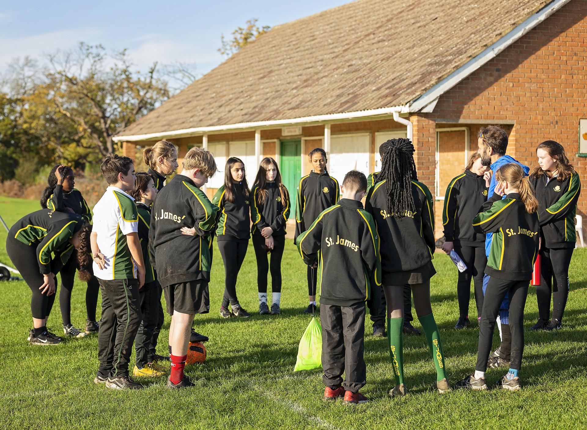 St James pupils together as a sports team on the field