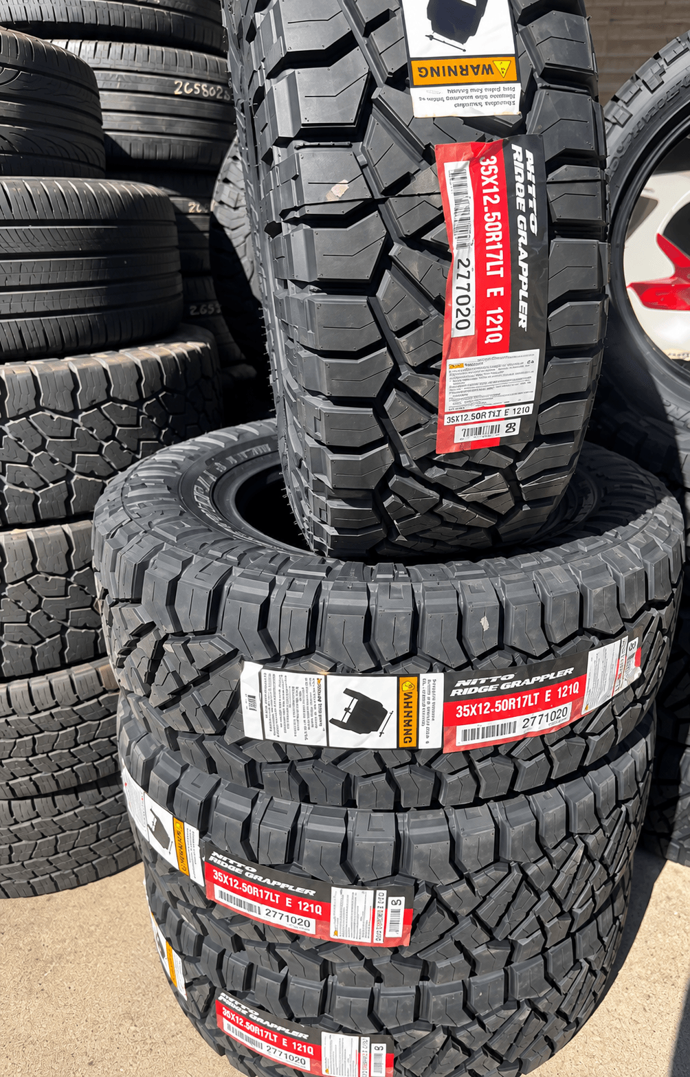 Stack of new tires at Xclusive Tire Inc