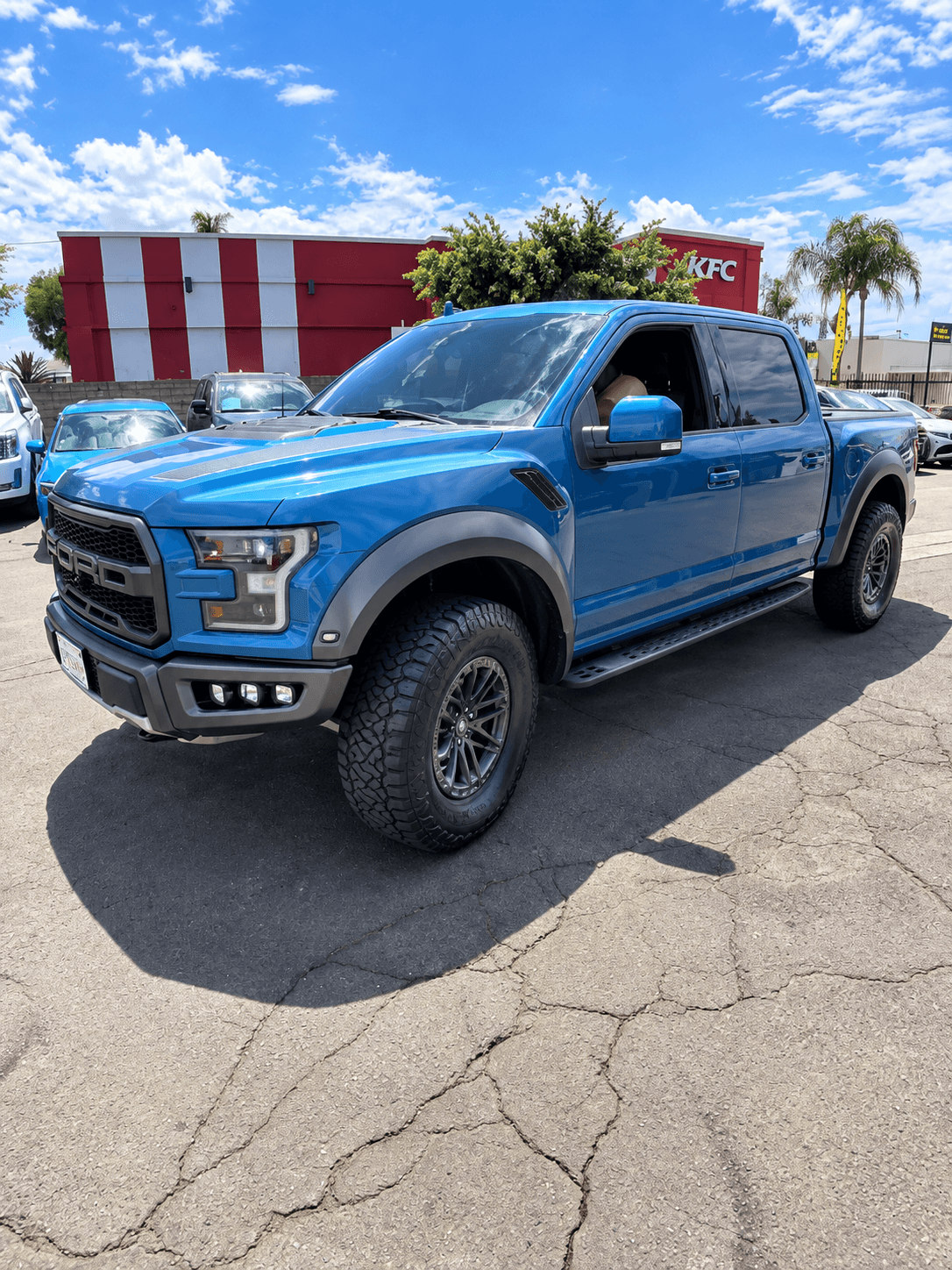 Blue truck with new tires at Xclusive Tire Inc