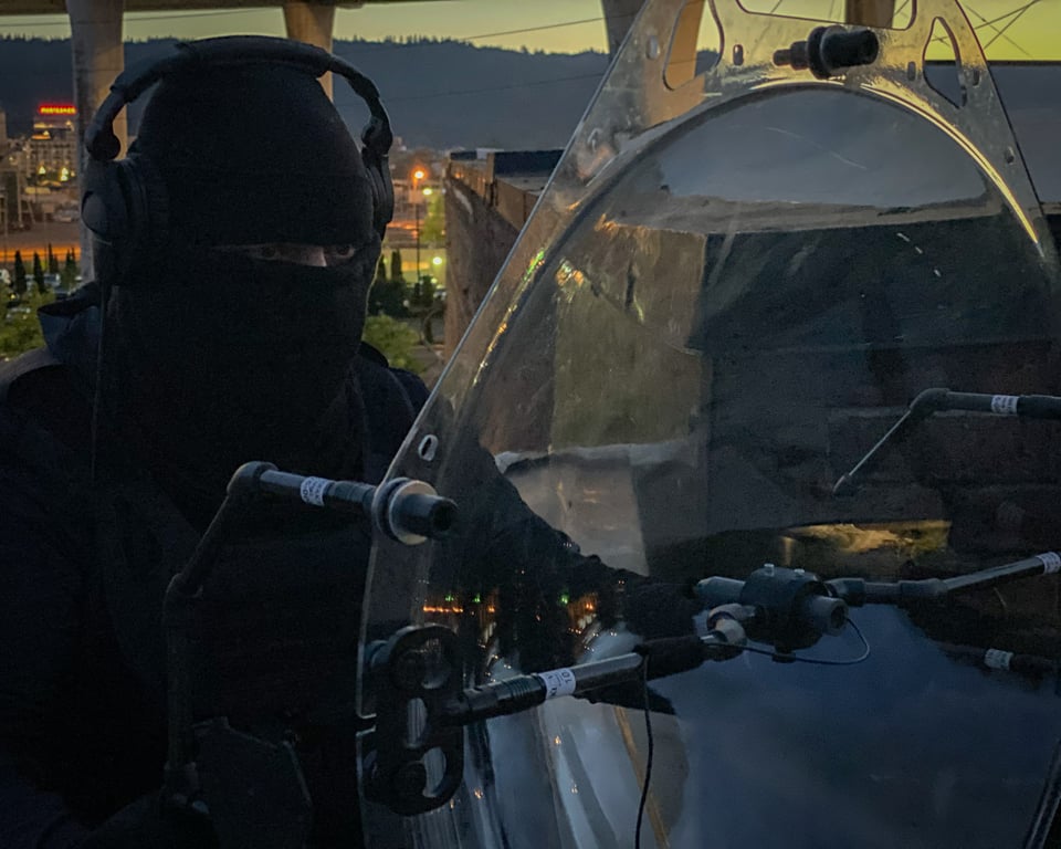 A security officer holding a KLOVER MiK 26 Stealth parabolic microphone