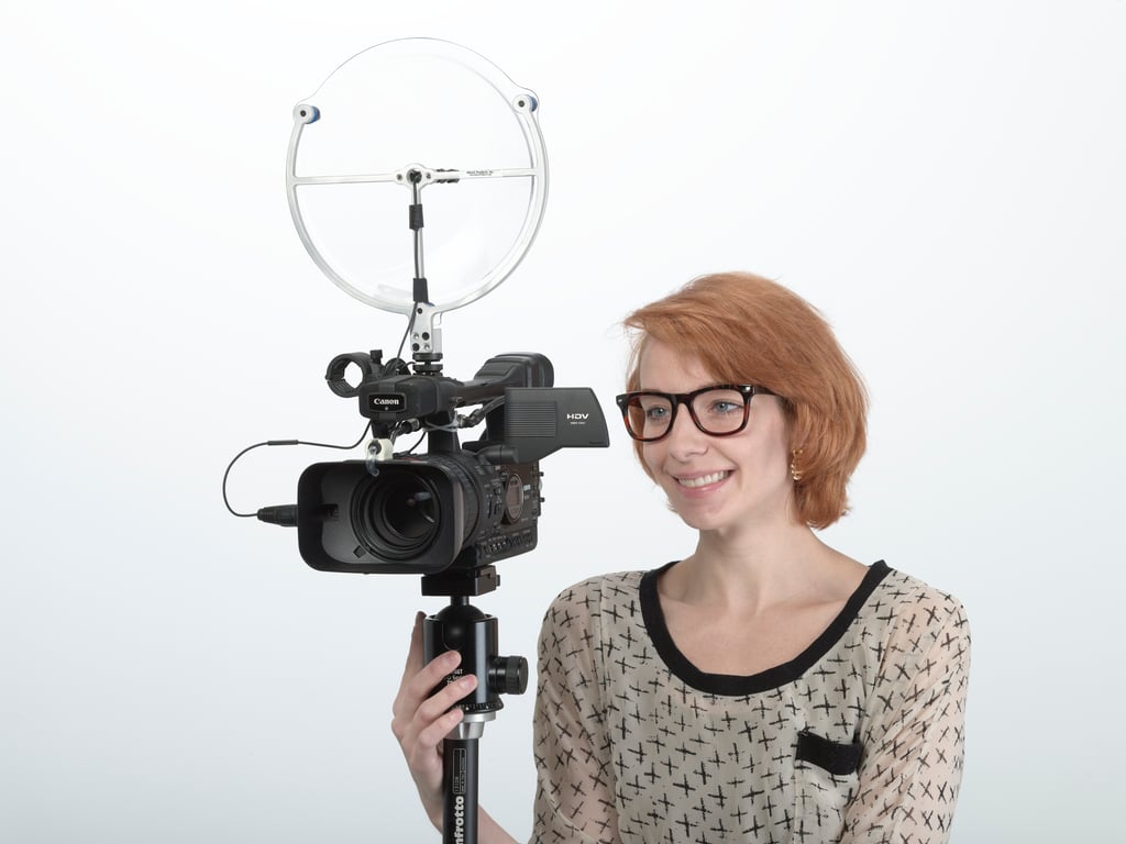 A woman with a video camera and KLOVER MiK 9 parabolic microphone