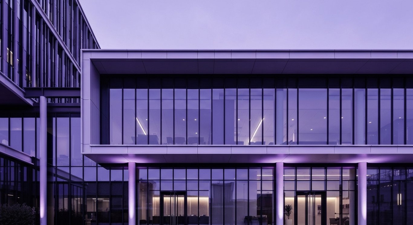 Corporate office building with glass and steel design, illuminated in purple tones