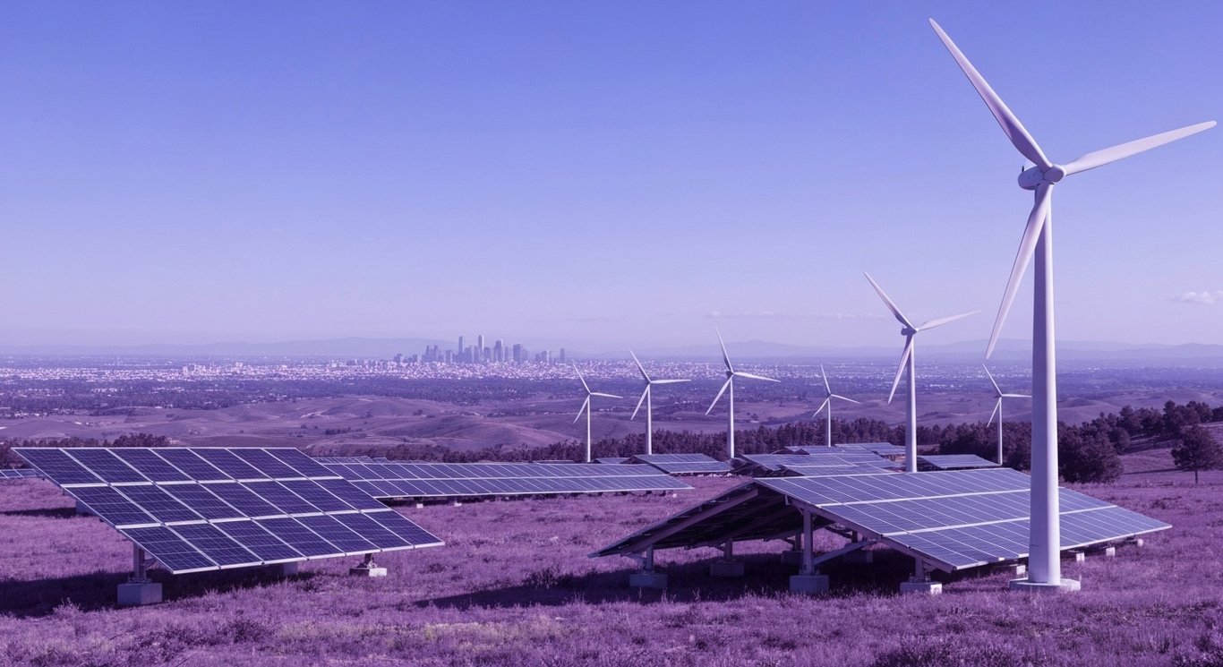 Advanced solar panels and wind turbines in a scenic landscape with a city skyline in the background