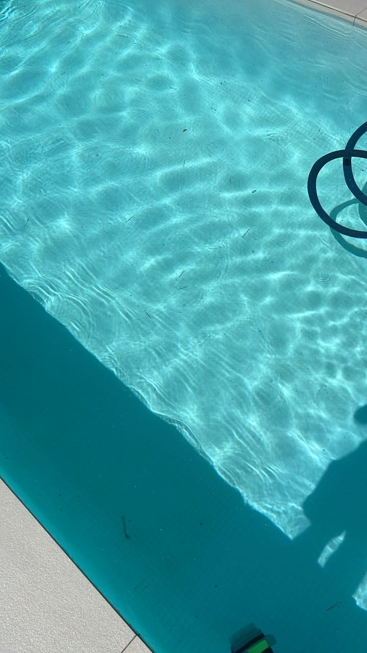 Before: Pool floor scattered with small debris