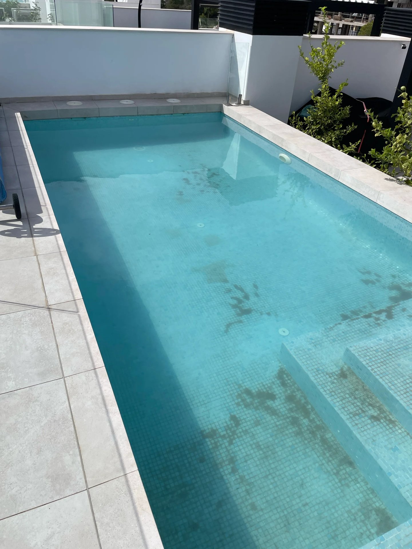 Pool floor dirty with sediment and debris