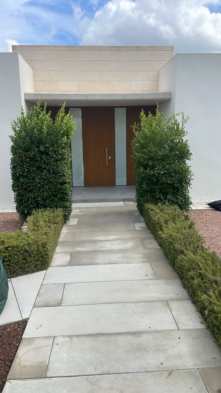 After: Entrance hedges trimmed and tidy