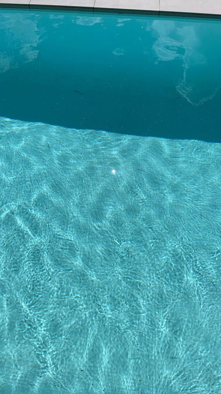 Before: Pool floor scattered with small debris