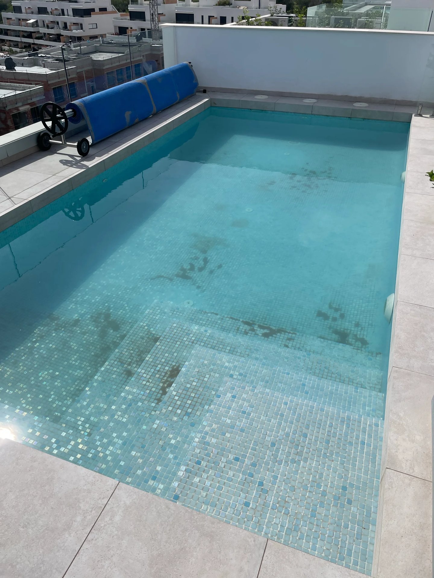 Pool floor dirty with sediment and debris