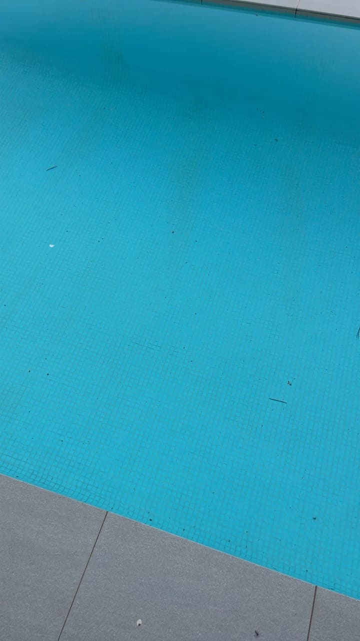 Before: Pool floor has scattered debris