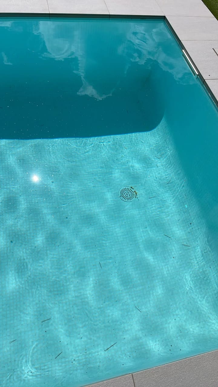 Before: Pool floor scattered with small debris