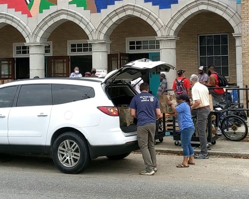 Volunteers loading up cars for delivery