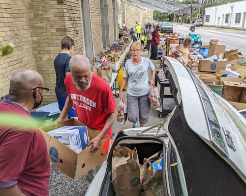 Volunteers Loading Car Trunks with Nutritious Groceries