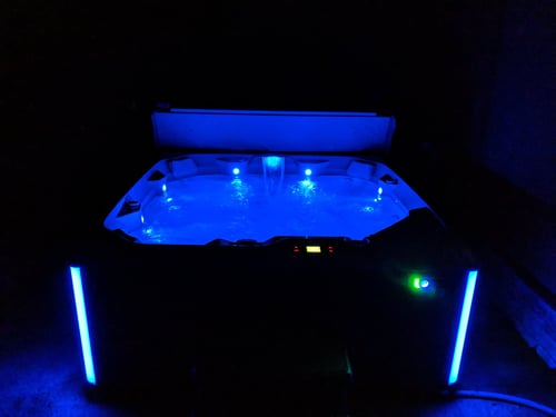 Private hot tub lit up at night