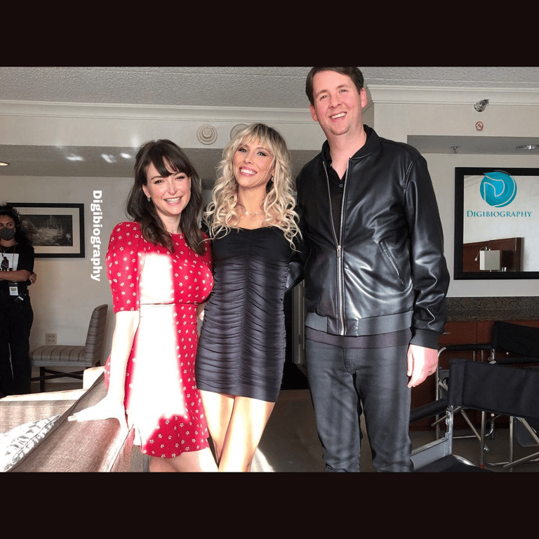 Milana Vayntrub stands with the family in his house while wearing a red white dotted dress