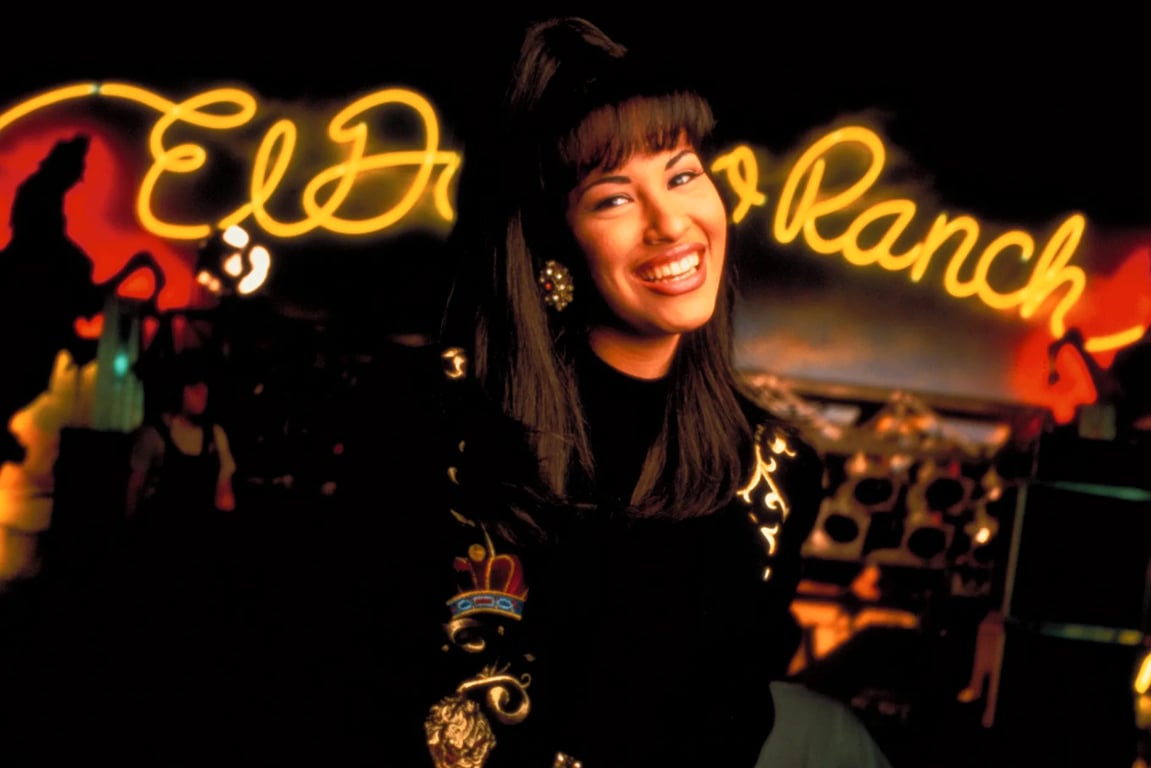 Selena Quintanilla giving a smile in a black dress