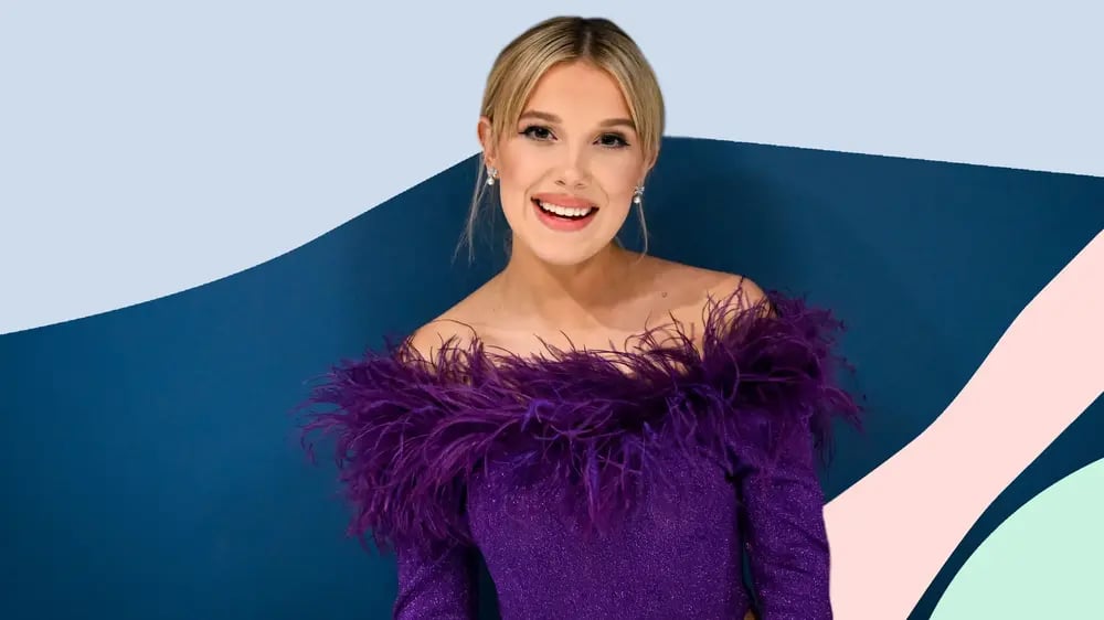 Millie Bobby Brown wearing a purple dress and smiling 