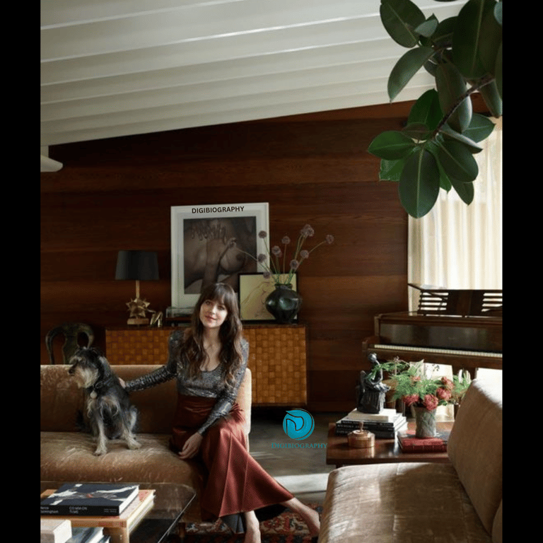 Dakota Johnson sitting on the sofa in her home 