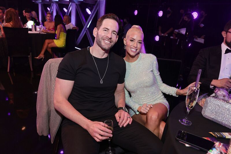 Tarek el Moussa sitting with Heather Rae Young in a club