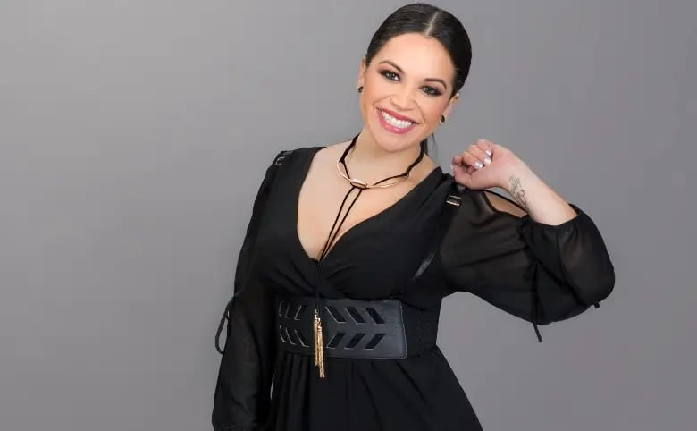 Jacqie Campos wearing a black dress and giving a smile
