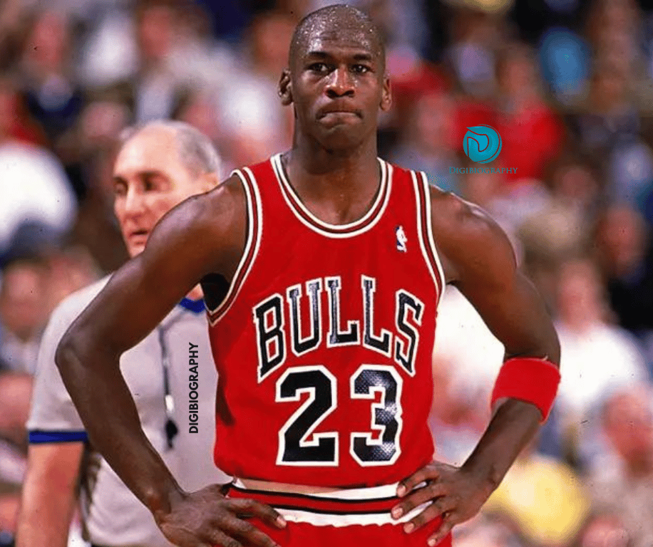 Michael Jordan wearing a red t-shirt and standing in the stadium