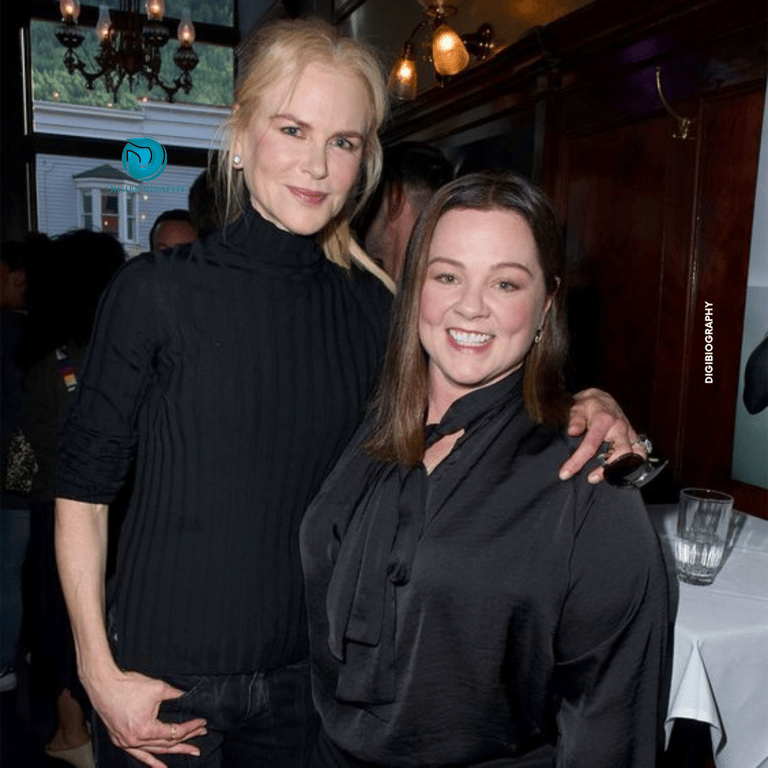 Melissa McCarthy stands with her co-actress and wears a black dress