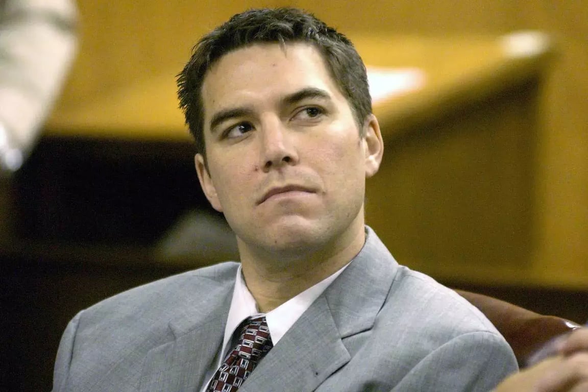 Scott Peterson sitting in a chair, wearing a gray suit