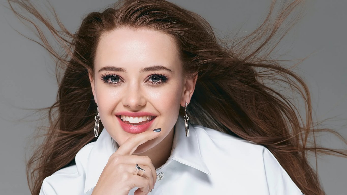 Katherine Langford wears a white top with the open hair