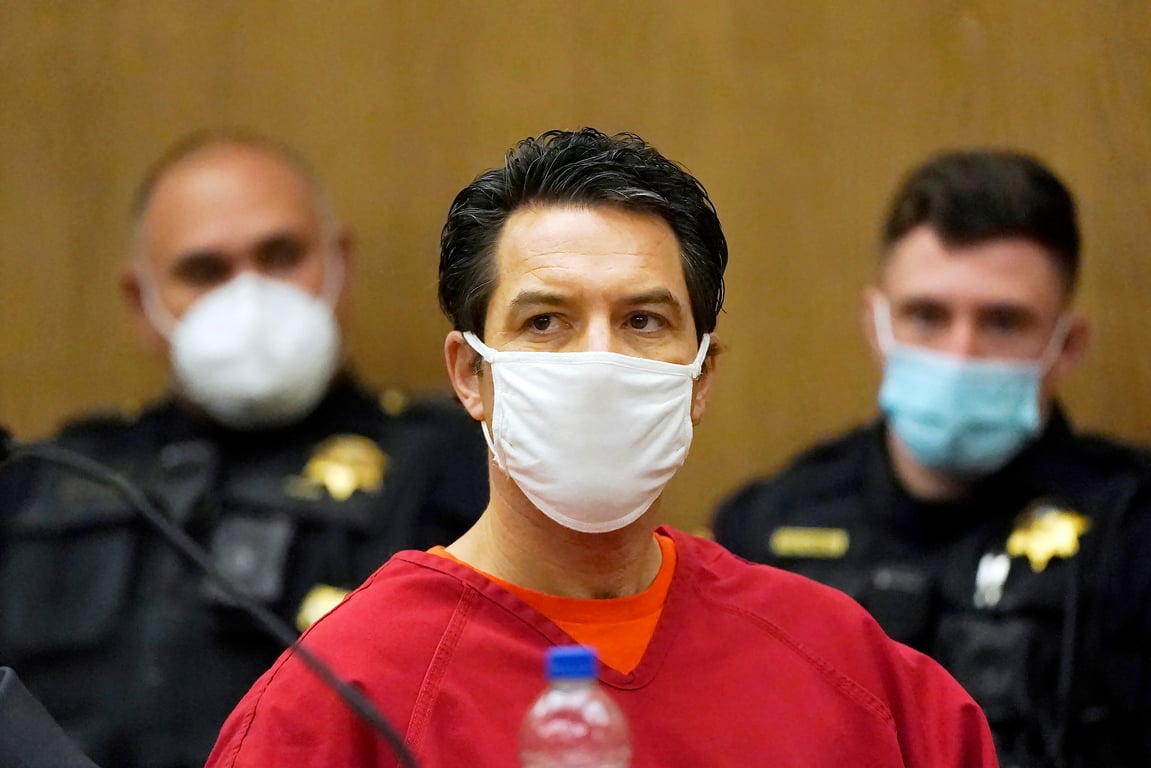  Scott Peterson sitting in the court room with police