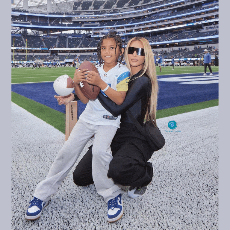 Kim Kardashian sitting in the stadium with her son