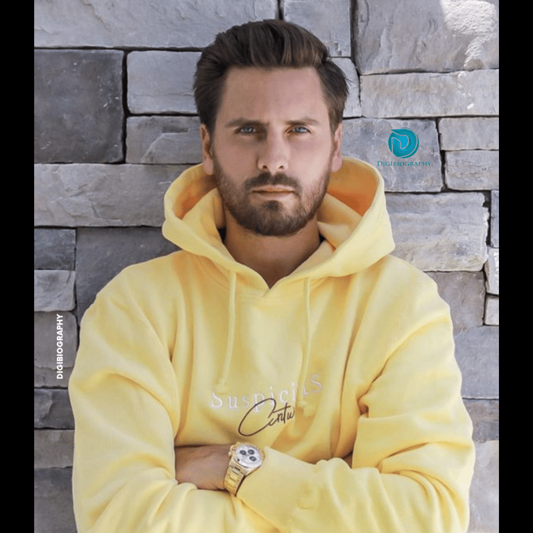 Scott Disick wearing a yellow hoodie and gives a look