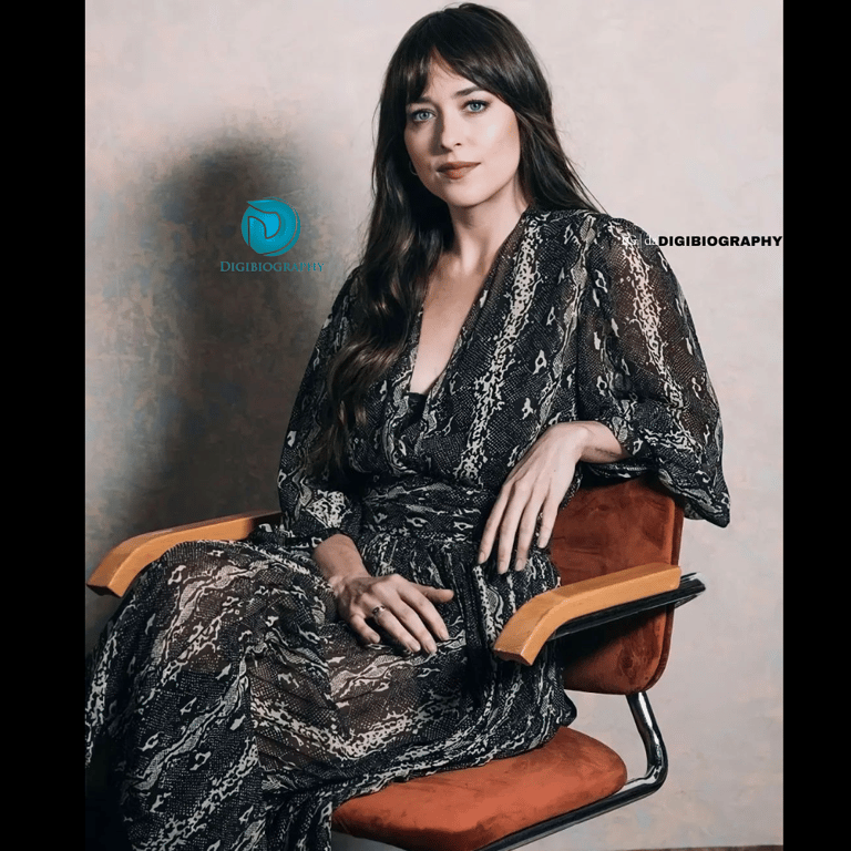 Dakota Johnson sitting on the chair while wearing a black dress