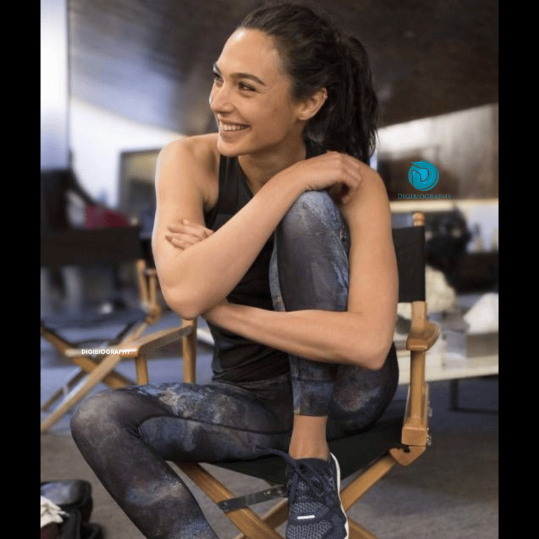 Gal Gadot sitting on the chair and wearing an excuse cloth