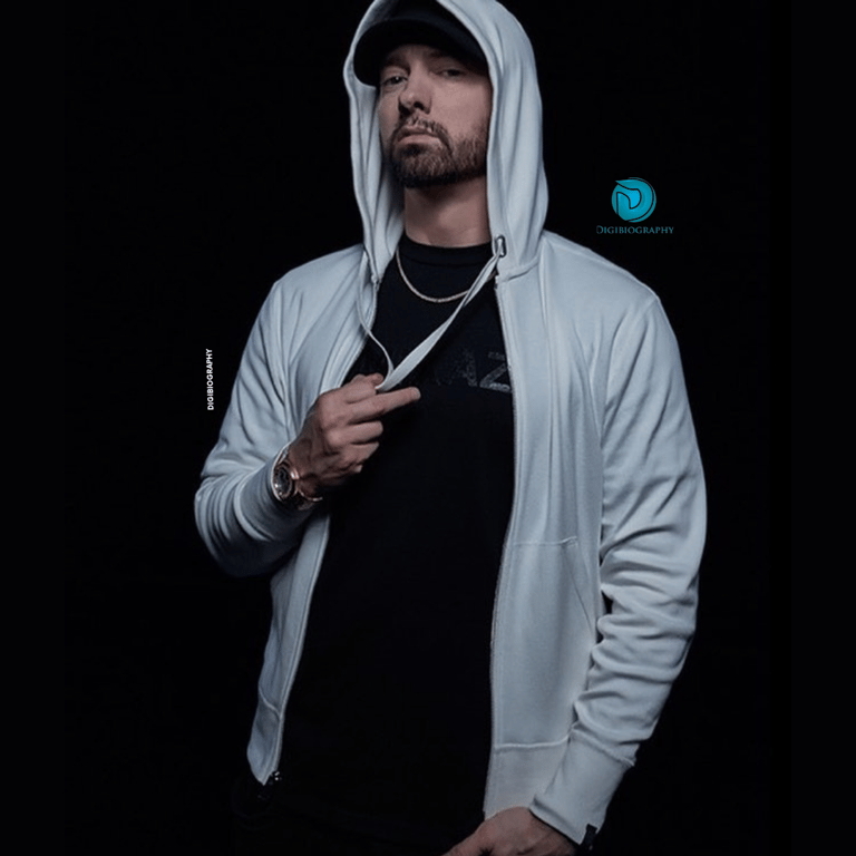 Eminem wearing a sky-blue hoddie and stand in black background