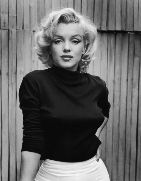 Marilyn Monroe wears a black top in the dark photo