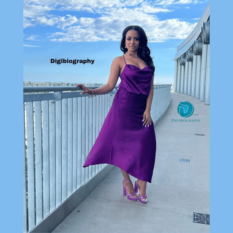 Kyla Pratt wears a purple dress and stands on the terrace