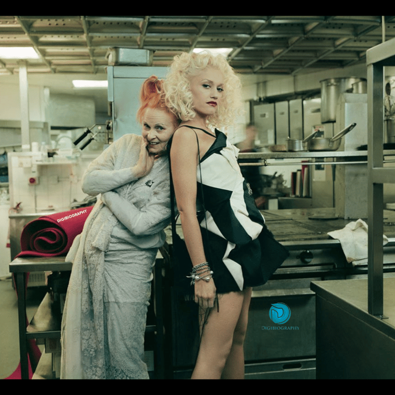 Gwen Stefani stands in the kitchen with her co-actor