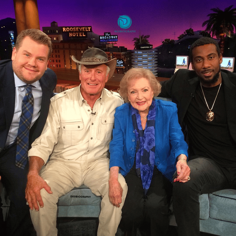 Betty White wearing a blue jacket and sitting with her friend