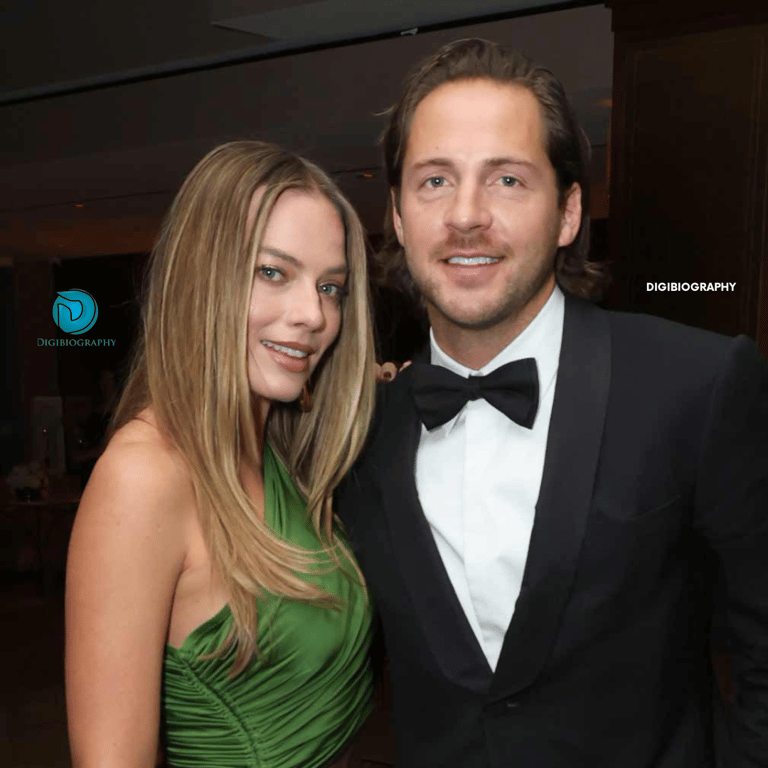 Margot Robbie stands with her husband tom and wearing a green dress
