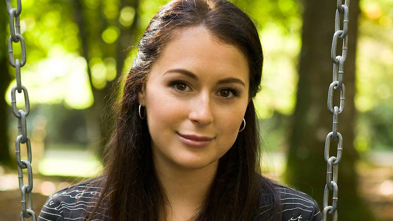 Alexa Vega sitting on the swing in the park 