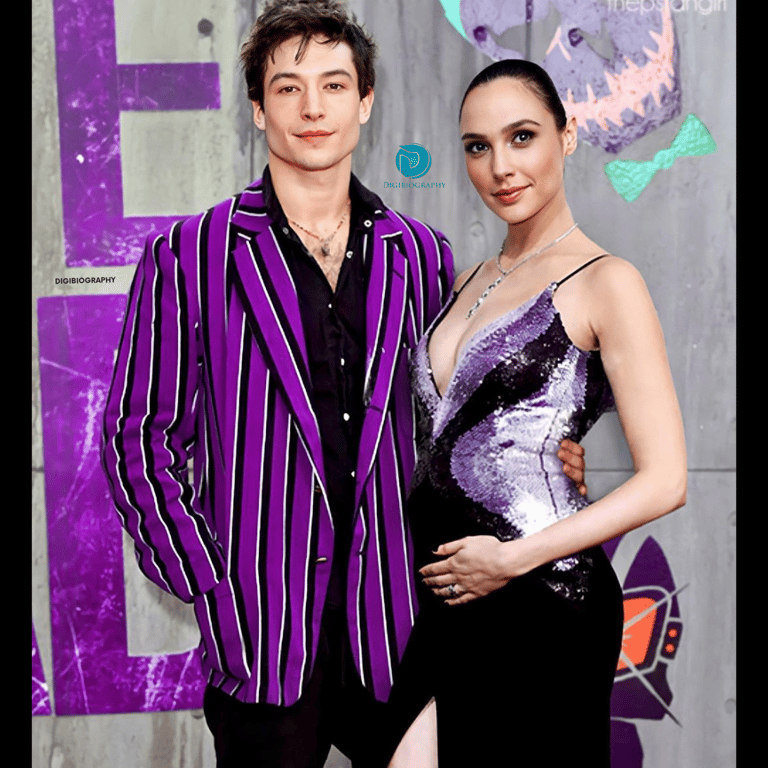 Ezra Miller stand with Gal Gadot while wearing a purple blazer 