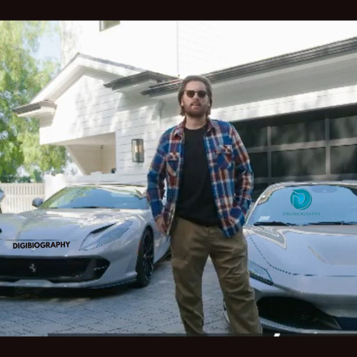 Scott Disick stands next to her cars