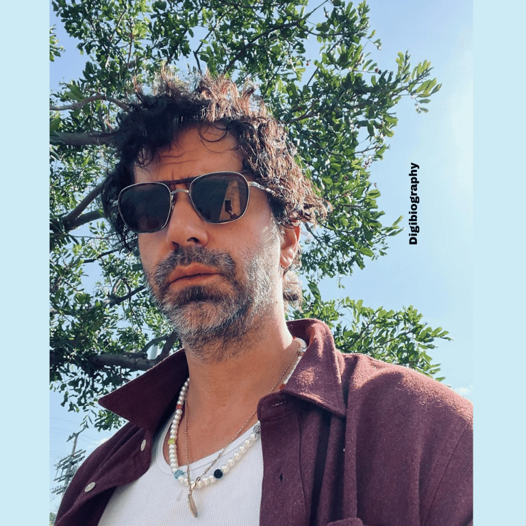 Hamish Linklater clicking a selfie in the open place and wearing a goggles