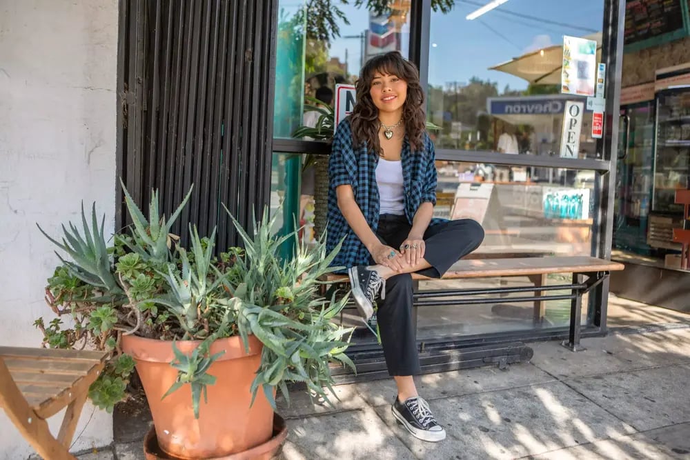 Xochitl Gomez's sitting outside of shop 