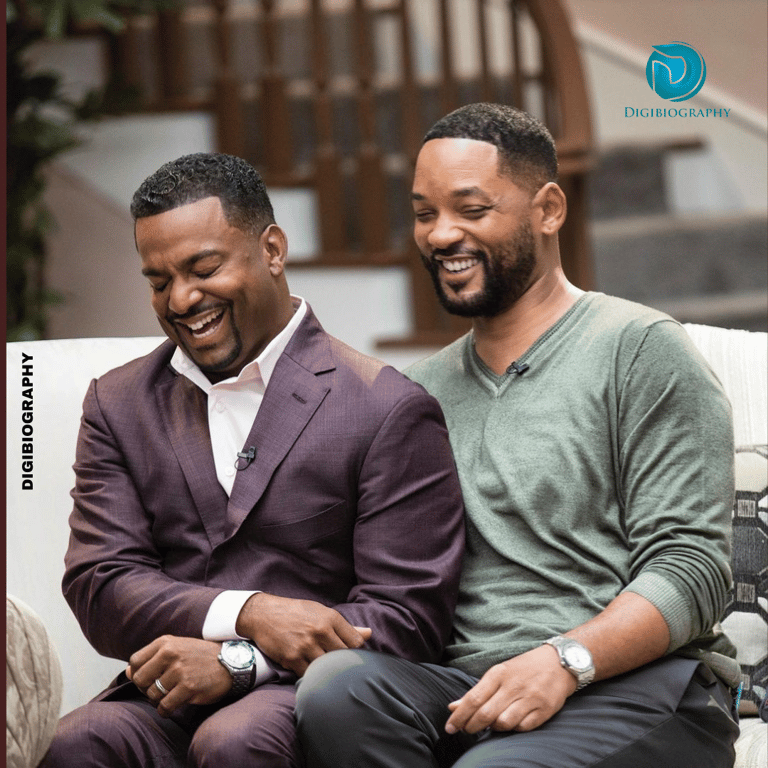Will Smith sitting with a friend in their house while wearing a light green t-shirt