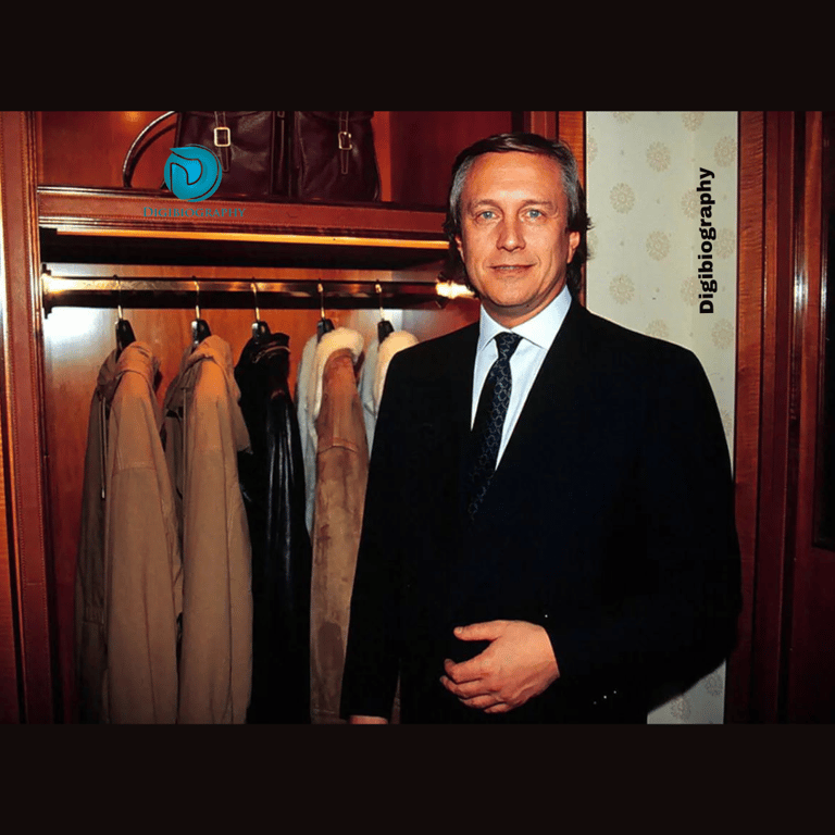 Maurizio Gucci stands in front of the cupboard while wearing a black suit