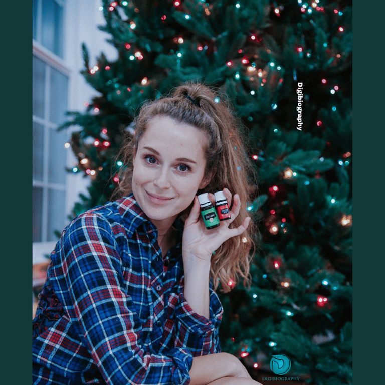 Alexa Vega sitting beside the Christmas tree while wearing a shirt
