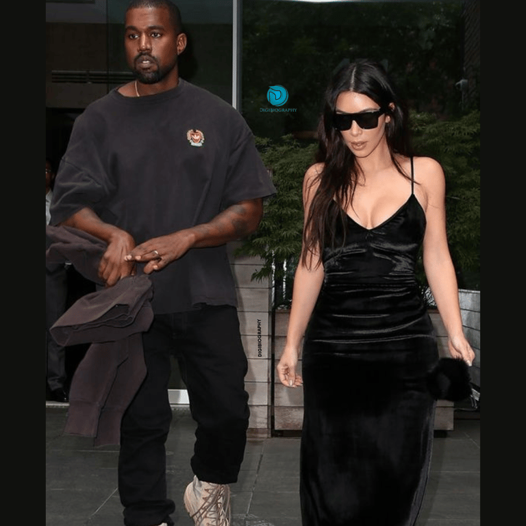 Kim Kardashian stands with her boyfriend Kanye West