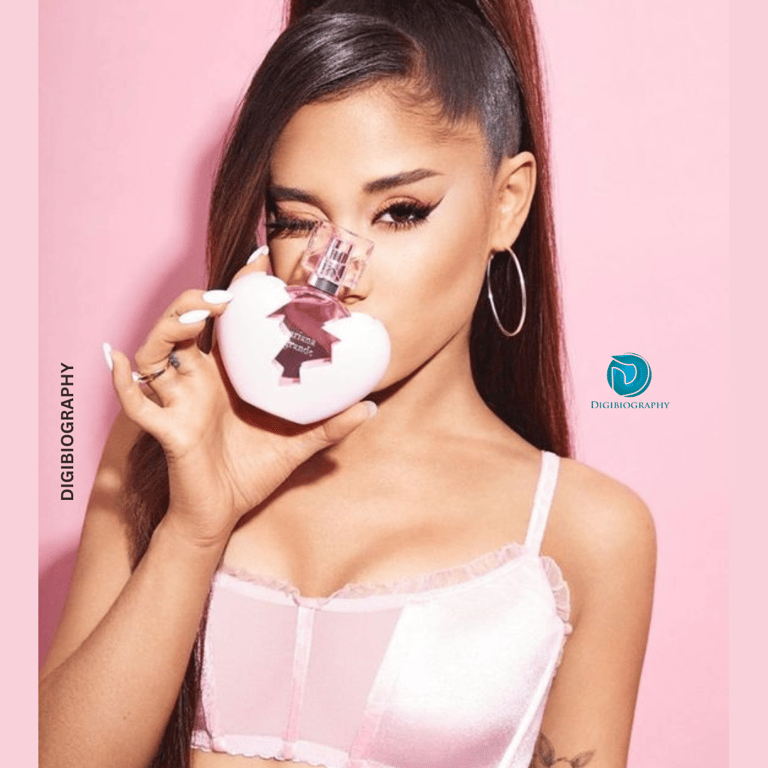 Ariana Grande shows her perfume brand while wearing a pink dress